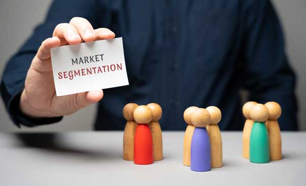 a person holding a card guiding customer segmentation strategy